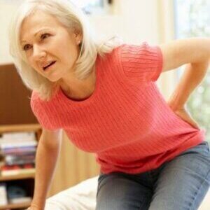 Adult experiencing lower back pain